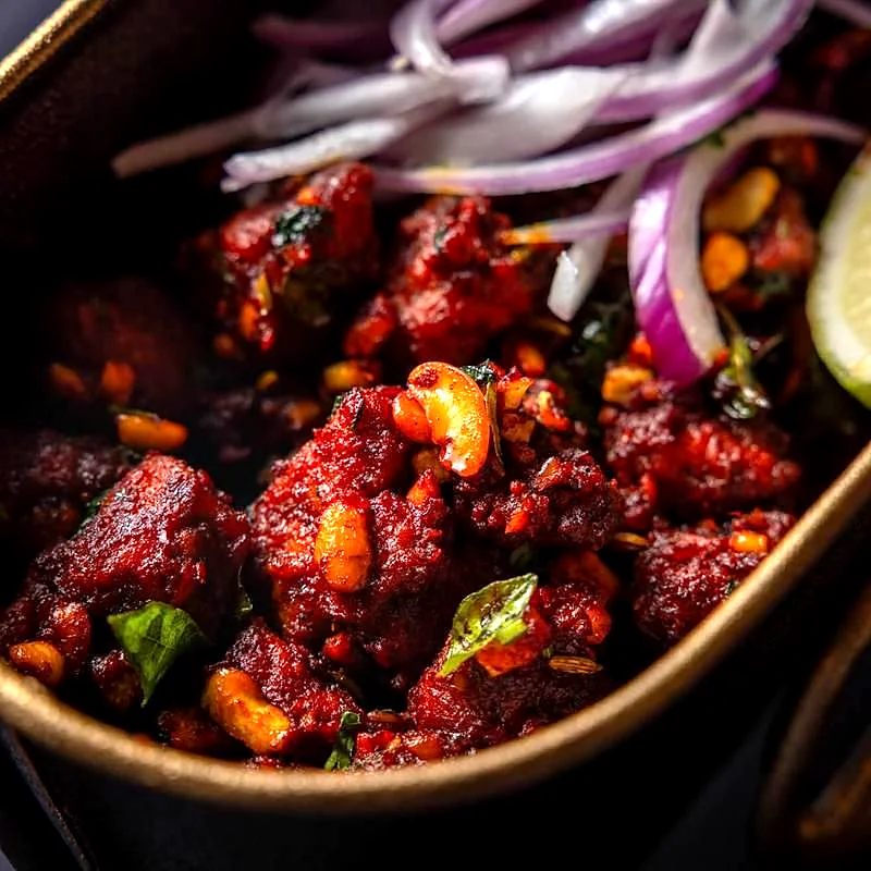 Spicy fried chicken with curry leaves and cashews